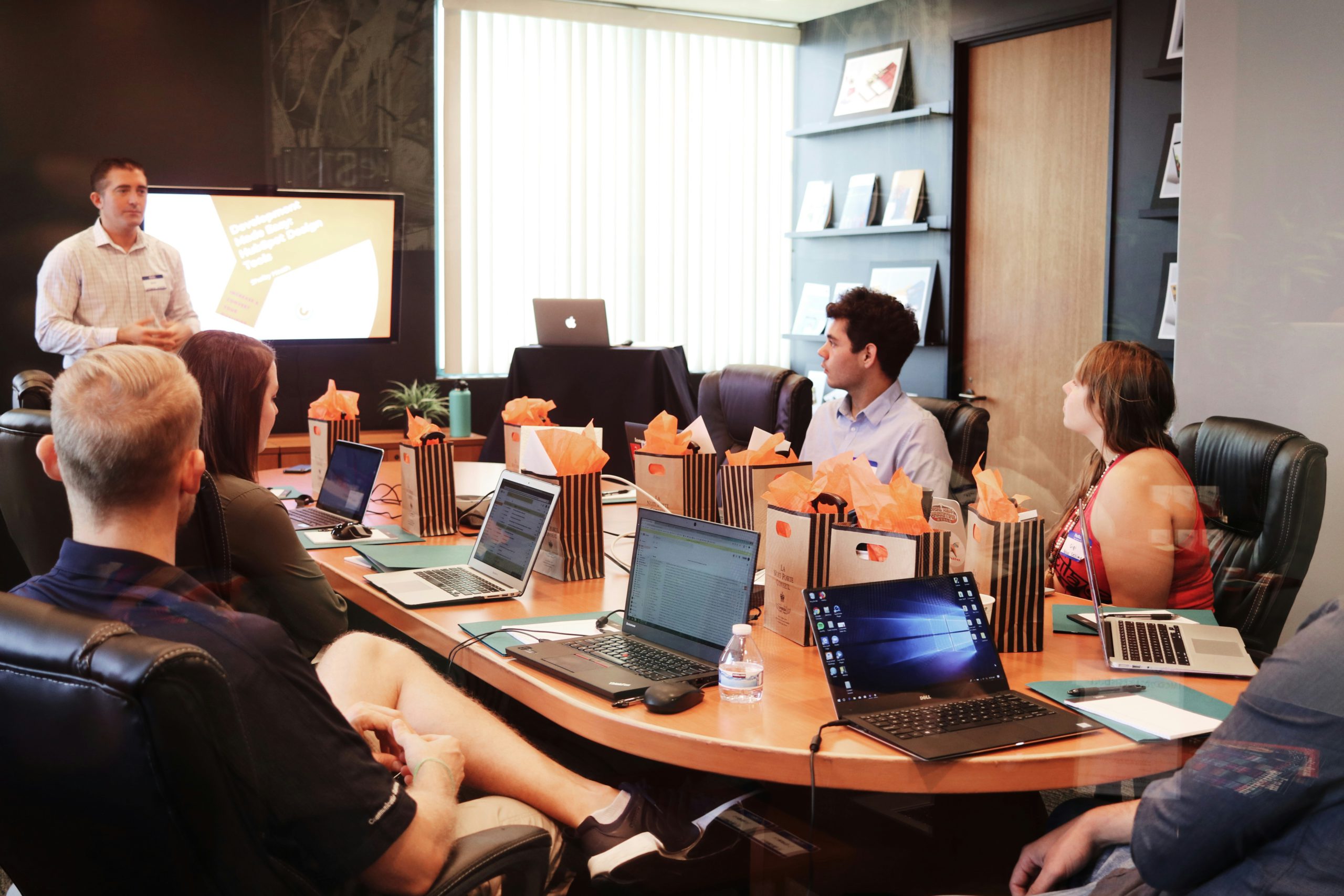 business people meeting in board room with laptops looking at presentation